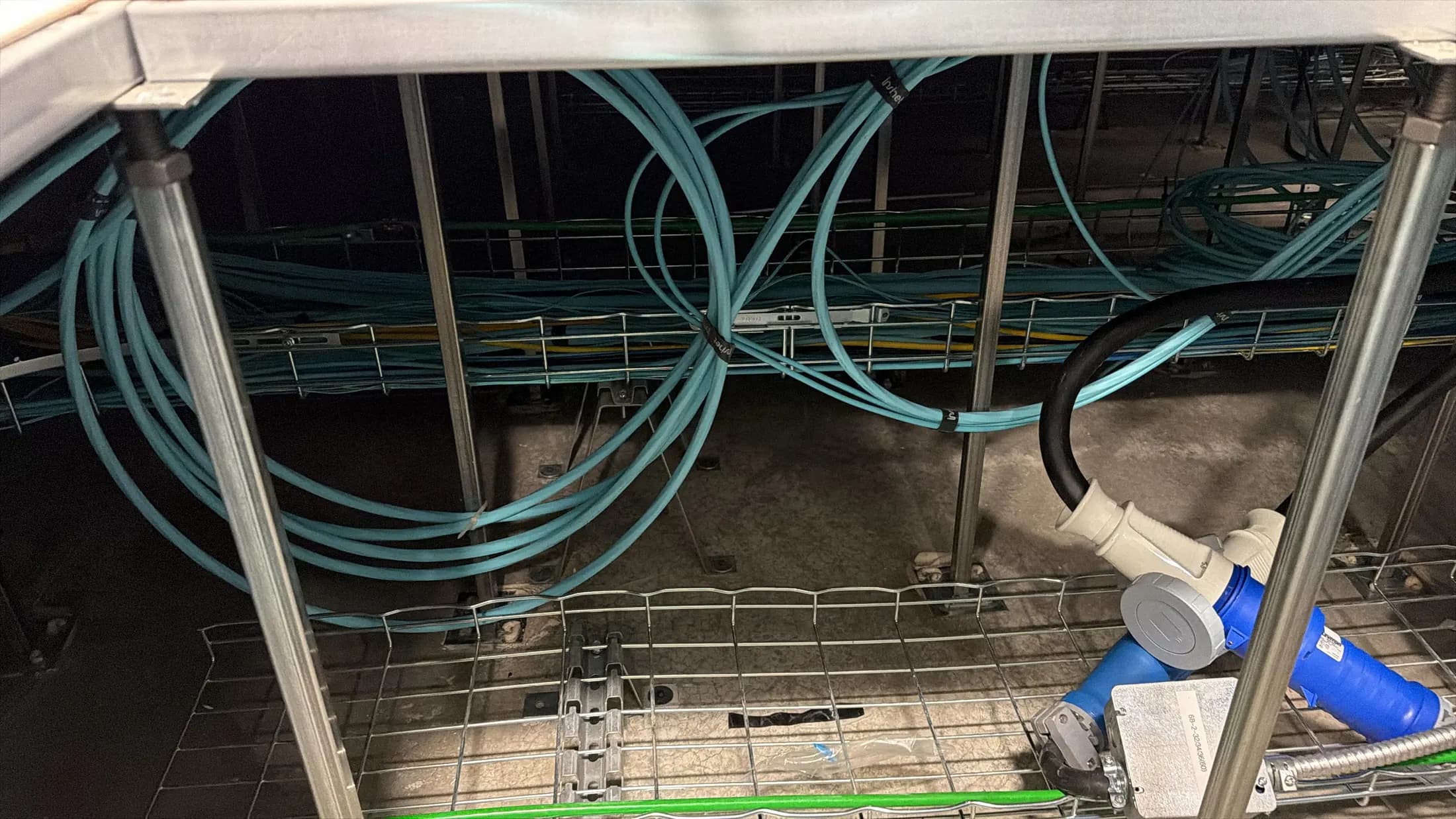 Multimode optical fiber pulled and organized under a datacenter's raised floor.