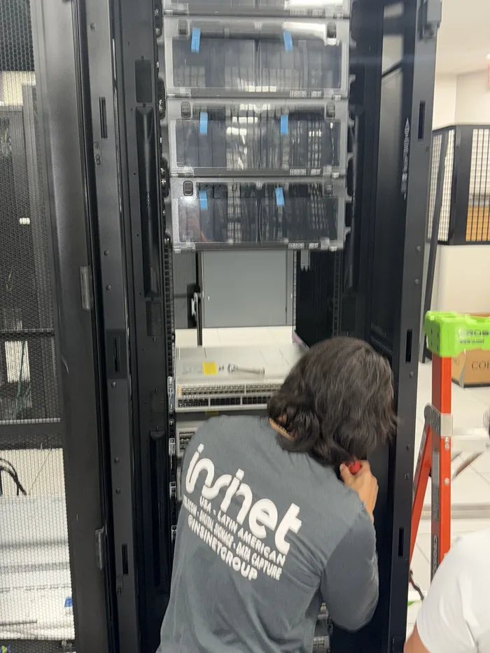 An Insinet technician working inside a datacenter rack.